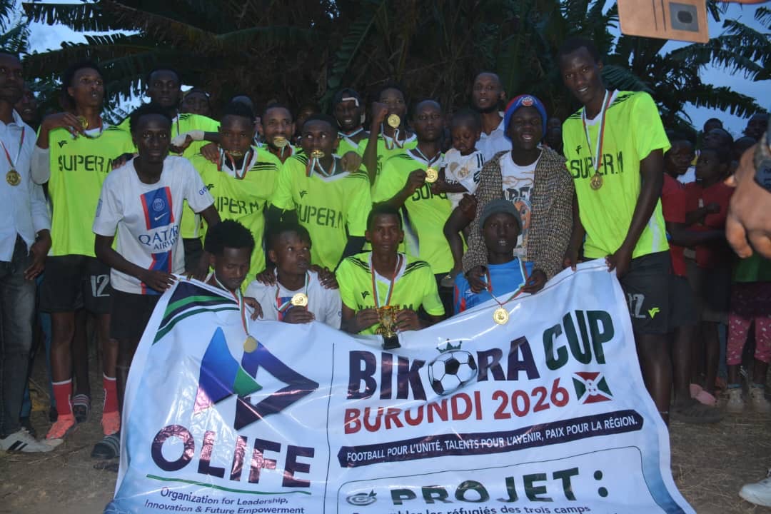 Football team with medals and BIKORA Cup banner